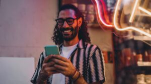 man looking for social media trends on his phone