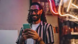 man looking for social media trends on his phone