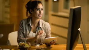 A woman is working behind a computer.