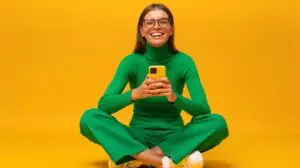 woman sitting down on her phone