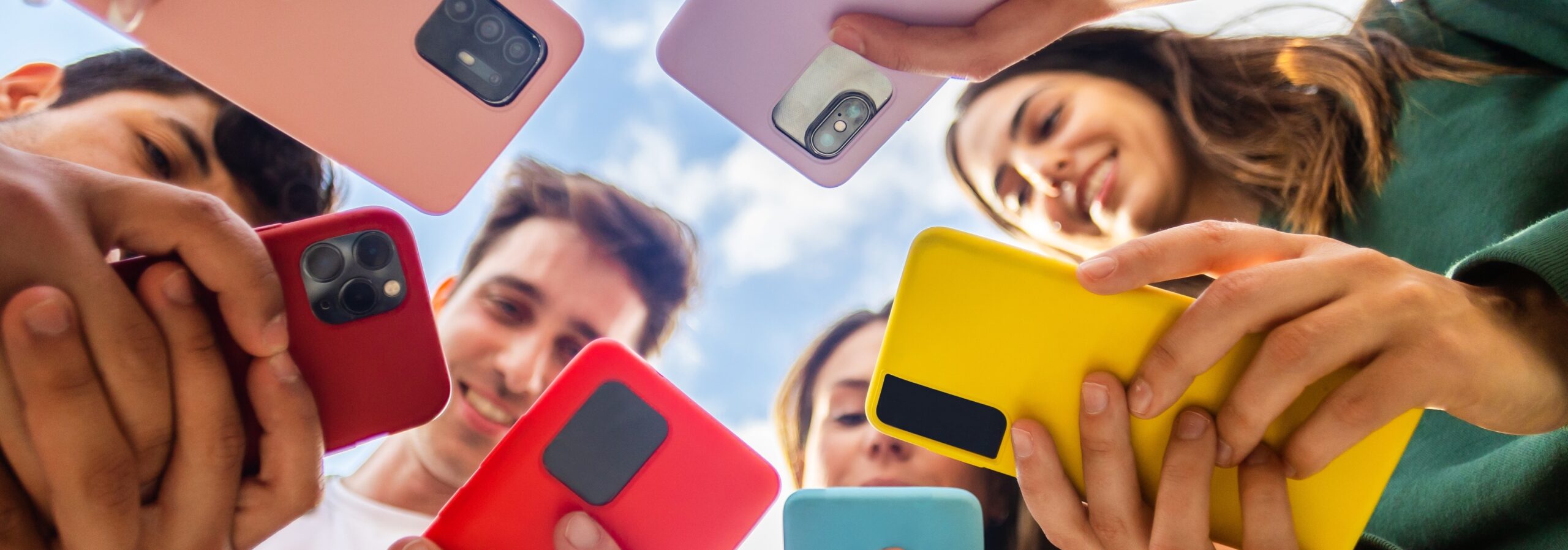 group of marketers in a circle on their phones