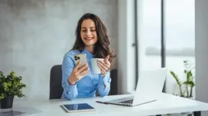 woman looking at a viral video idea on her phone