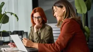 two women studying a tiktok trend on a computer