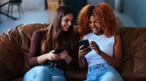2 woman on their phones watching social media trends