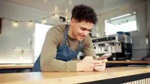 man scrolling on his phone