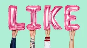 TikTok influencers holding up letters spelling out the word "like"