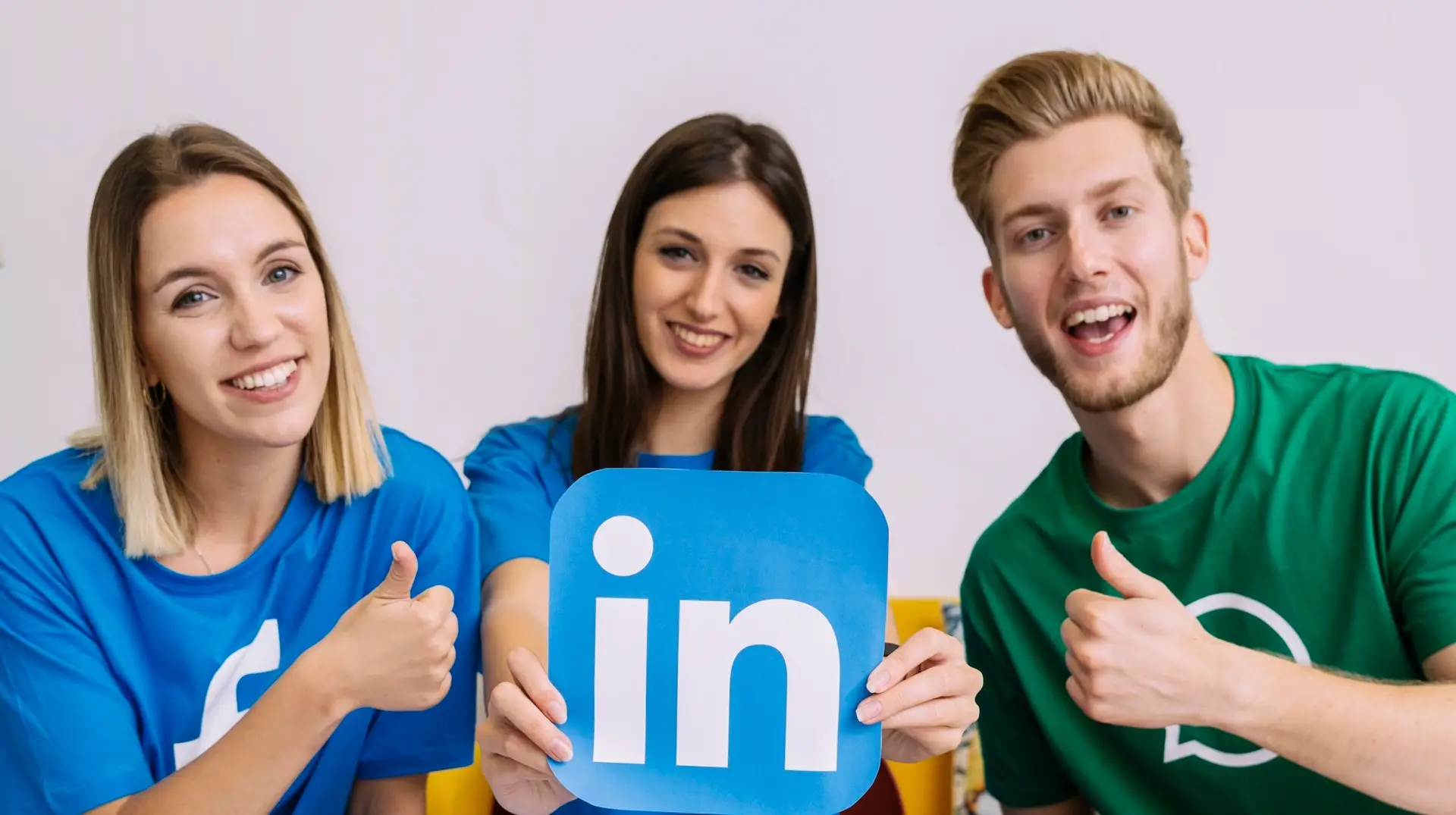 Group of marketers holding up the LinkedIn logo cutout