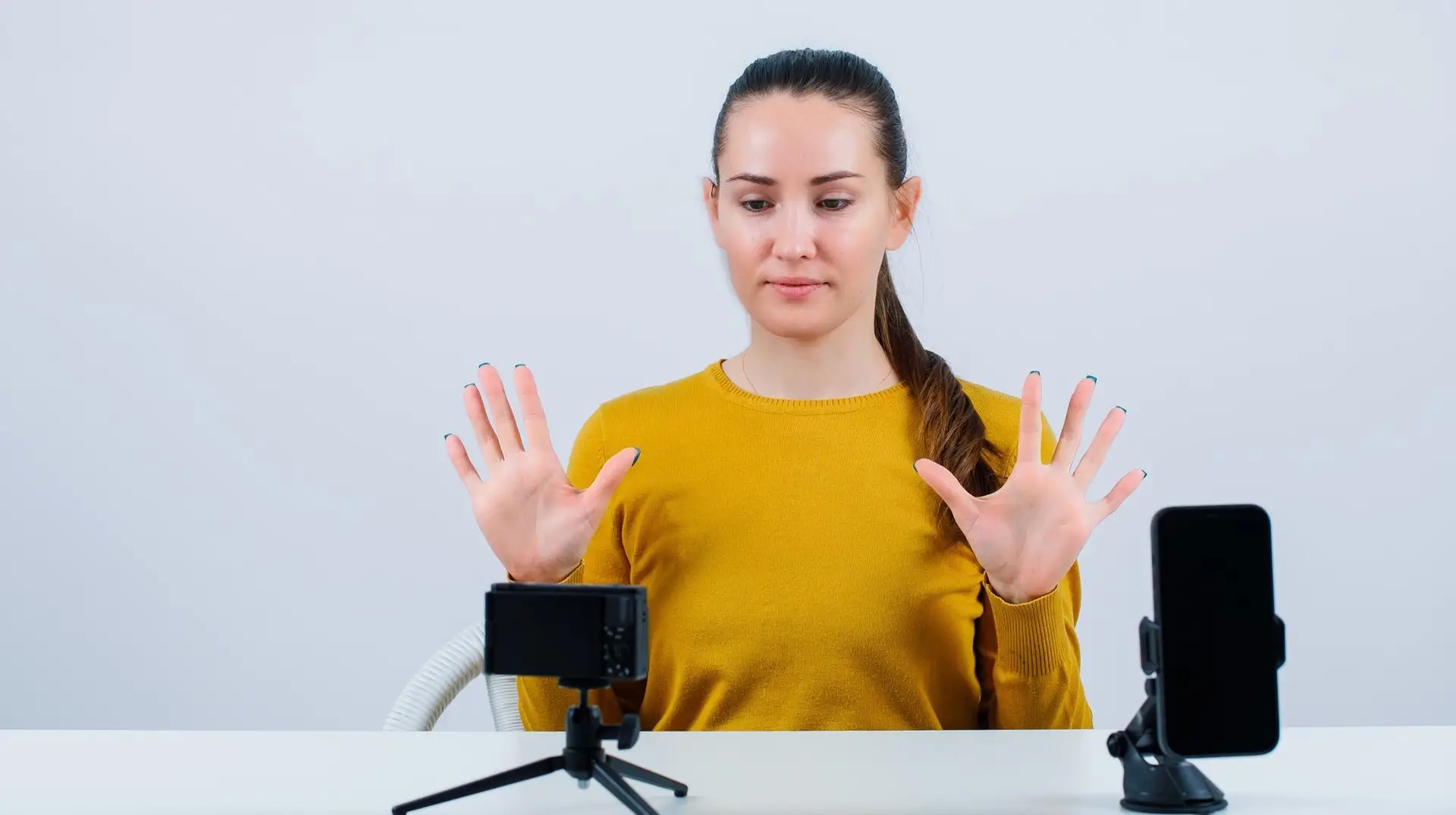 Woman showing the stop hand gesture with both hands