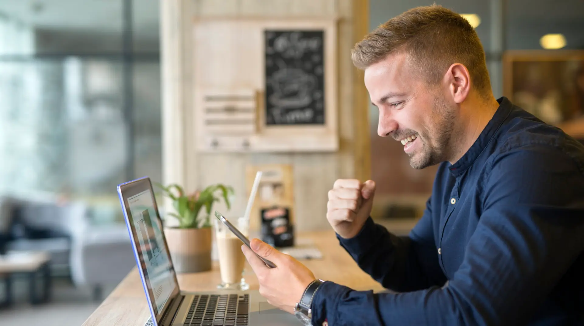 Happy marketer with laptop working