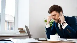 Upset young businessman speaking on phone