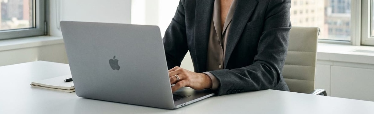 woman on a macbook searching for marketing trends