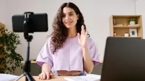 Woman recording a video on her phone to promote her online course